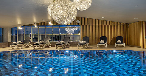 Schwimmbad Schwimmbad mit blauen Fliesen und Liegen im Maritim Hotel München