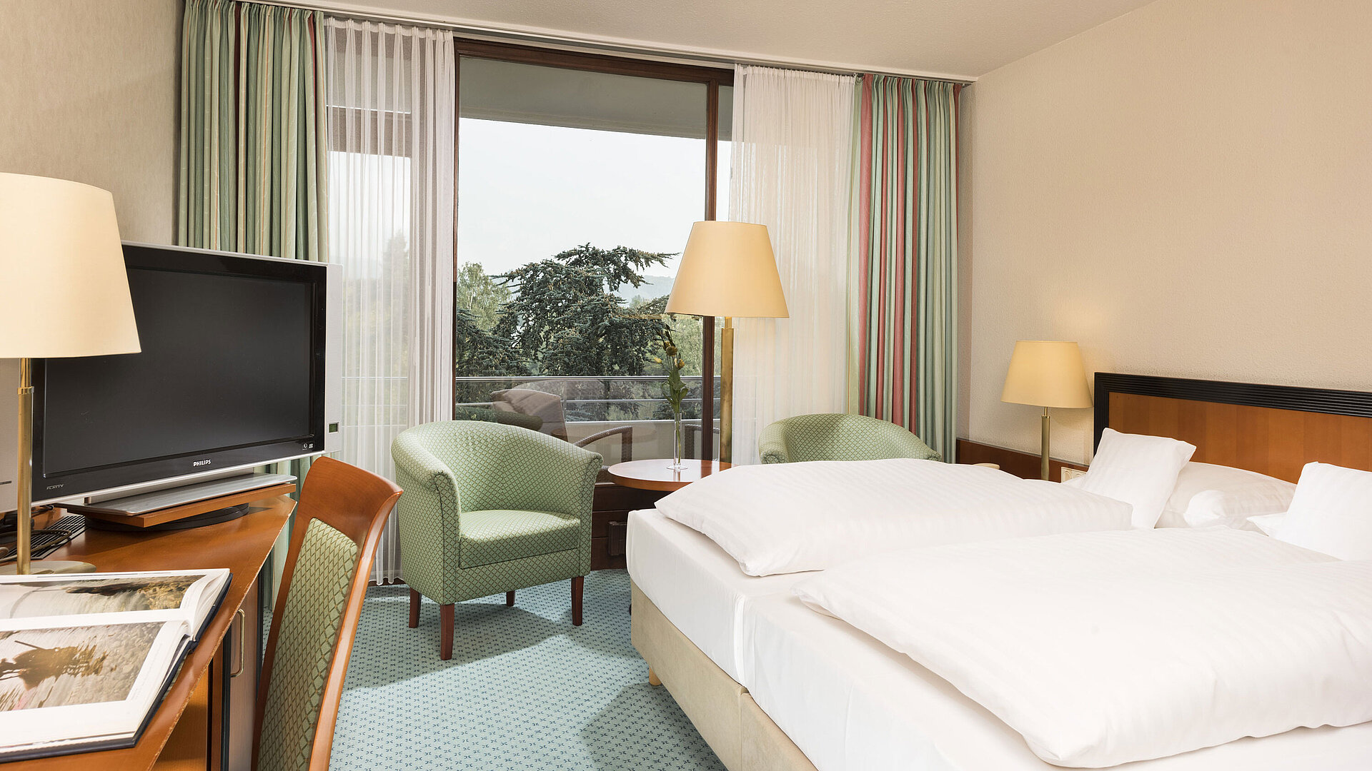 Superior Zimmer Helles Hotelzimmer im Maritim Hotel Bad Salzuflen mit Doppelbett, Sitzbereich und Zugang zum Balkon mit Ausblick
