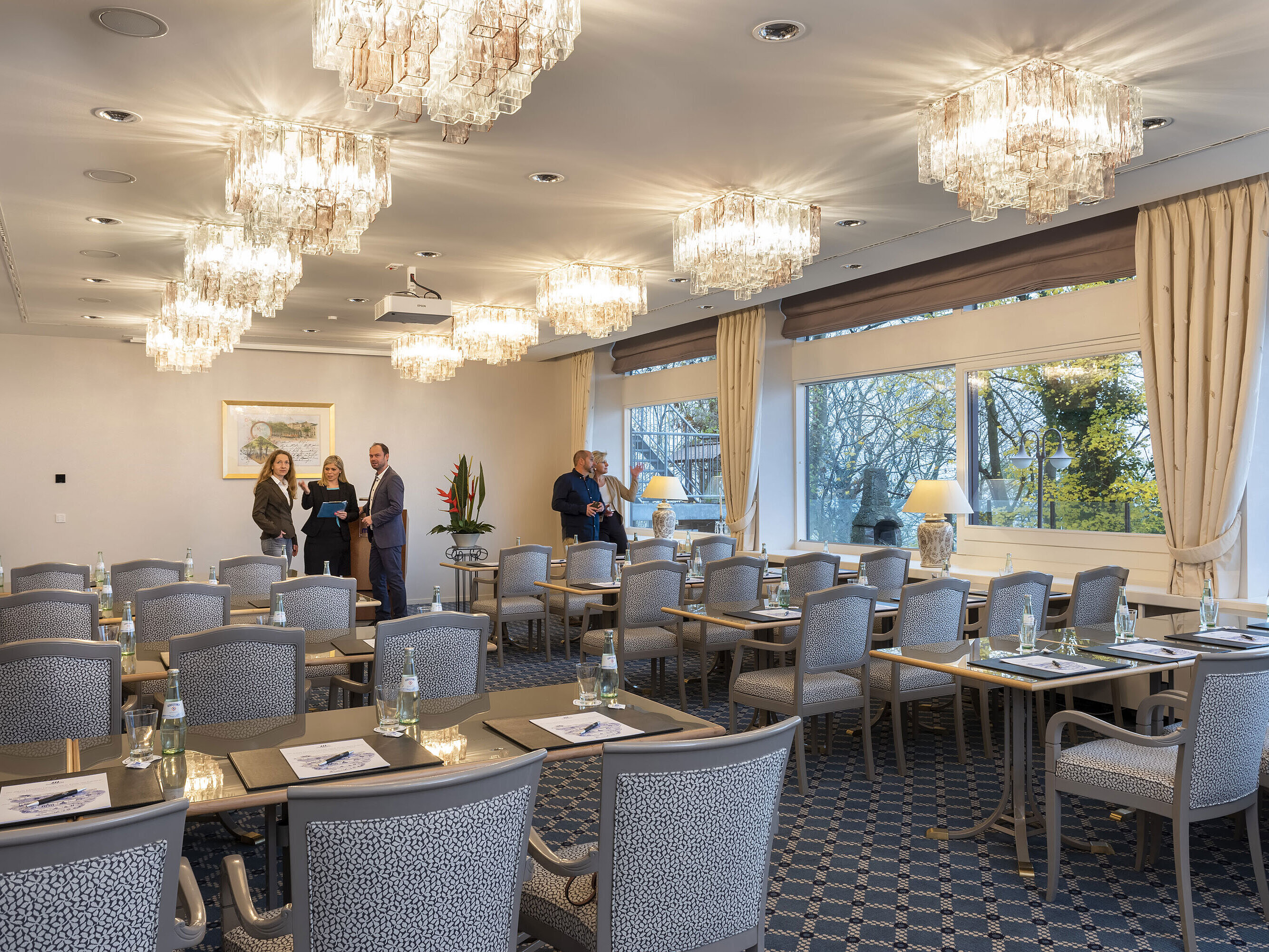 Salon Kopenhagen Der Salon Kopenhagen im Maritim Hotel Kiel, ein eleganter Konferenzraum mit Kronleuchtern, gedeckten Tischen und großen Fenstern.
