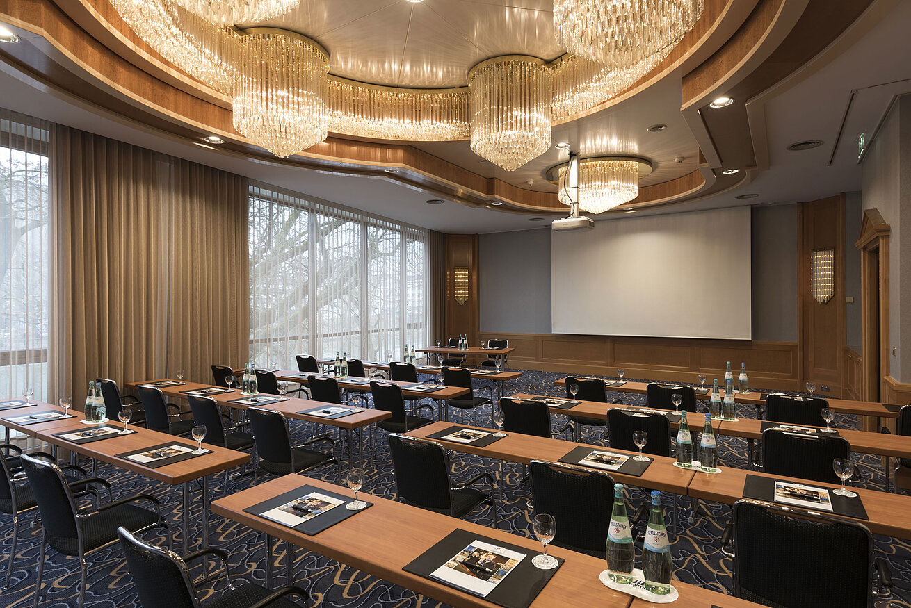 Saal Bonn Parlament Eleganter Tagungsraum mit Reihenbestuhlung, Kronleuchtern und Projektionsfläche im Maritim Hotel Ulm.