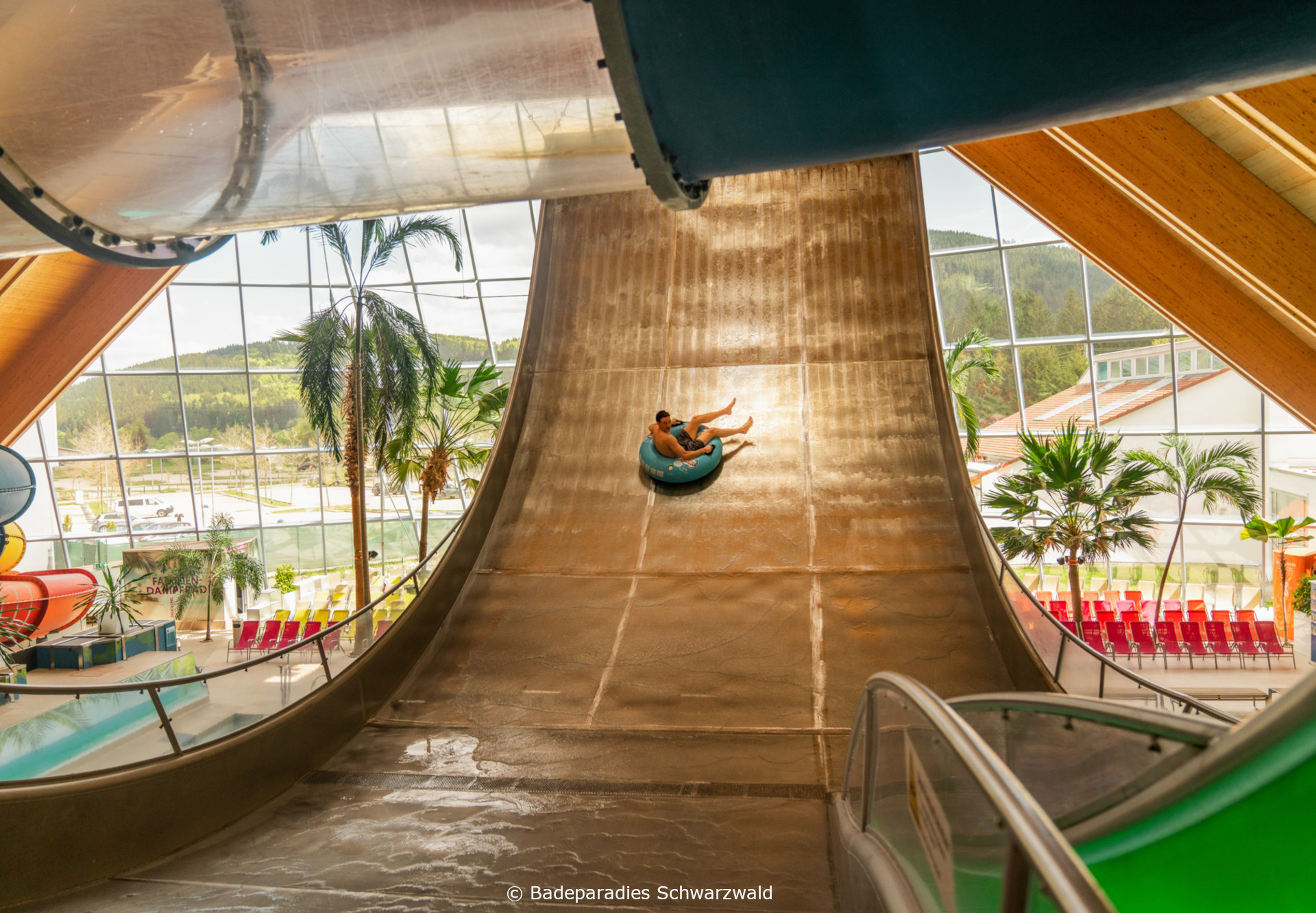 Galaxy © Badeparadies Schwarzwald Person rutscht auf großer Indoor-Wasserrutsche in modernem Wasserpark